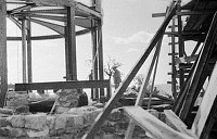 WATCHTOWER CONSTRUCTION SITE. KIVA SCAFFOLDING ON RIGHT TO WATCHTOWER FRAMEWORK ON LEFT. CIRCA 1931. COLTER