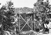 WATCHTOWER CONSTRUCTION SITE. SCAFFOLDING AROUND KIVA WALL. CIRCA 1931. COLTER.