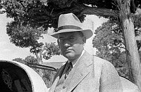 PORTRAIT OF SANTA FE RR OFFICIAL AT WATCHTOWER CONSTRUCTION SITE. CIRCA 1932. COLTER.