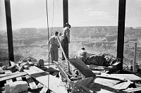 INSIDE WATCHTOWER DURING CONSTRUCTION SHOWING TOWER FRAMEWORK. 2 WORKMEN - CANYON BEHIND. CIRCA 1932. COLTER. 