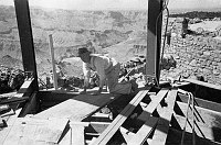 INSIDE WATCHTOWER DURING CONSTRUCTION SHOWING TOWER FRAMEWORK. KIVA BEHIND. CIRCA 1932. COLTER. 