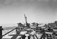 DESERT VIEW WATCHTOWER CONSTRUCTION SITE. VIEW OF SCAFFOLDING WITH WHEELBARRELS ON EDGE OF PLANKING. CIRCA 1932. COLTER