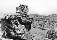 M.J. COLTER USED AS MODEL FOR D.V. WATCHTOWER. BOULDER RUIN, BROWN'S RANCH, CO. CIRCA 1931. FRED HARVEY CO. 