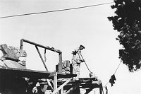 WORKER ON SCAFFOLDING. ROCK WALL & WOOD FRAME FOR WINDOW VISIBLE. WATCHTOWER. CIRCA 1932, HIRCHBORN