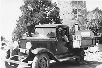 CONTRACTOR HIRCHBORN ??? IN HIS TRUCK. WATCHTOWER CONSTRUCTION IN BACKGROUND. CIRCA 1932, HIRCHBORN