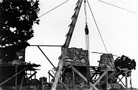 PARTIALLY COMPLETED DESERT VIEW WATCHTOWER KIVA WALL. WINCH. SCAFFOLDING. LADDER. CIRCA 1932, HIRCHBORN