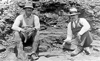 PALEONTOLOGISTS, DR. DAVID WHITE AND DR. JOHN C. MERRIAM SITTING AT CEDAR RIDGE FOSSIL QUARRY. CIRCA 1927. NPS.