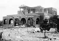 VERKAMP'S STORE WITH RUGS OUTSIDE. SIGNS READ: CANYON SOUVENIRS, NAVAJO BLANKETS. CIRCA 1910. GRAND CANYON N.P. MUSEUM COLLECTION