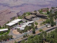 AERIAL VIEW OF THE EL TOVAR HOTEL, HOPI HOUSE, COLTER HALL AND KACHINA LODGE. PASSENGER TRAIN AT THE STATION, GRAND CANYON N.P. VILLAGE. NPS PHOTO. 