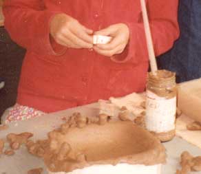 A Child working with clay in the Children's Workshops in Clay course