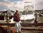 George in front of JFK's yacht