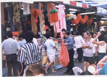 A saleman shouting to his customers:'Why so cheap here? Don't look elsewhere & get lost, turn your heads to look here for more cheap deals ...'