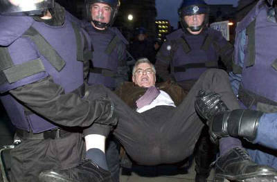Joe Higgins TD, getting 'helped off' the road outside the Dail during an anti-war protest. 