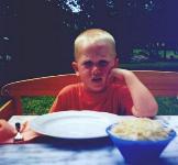 [Dani sits at table]