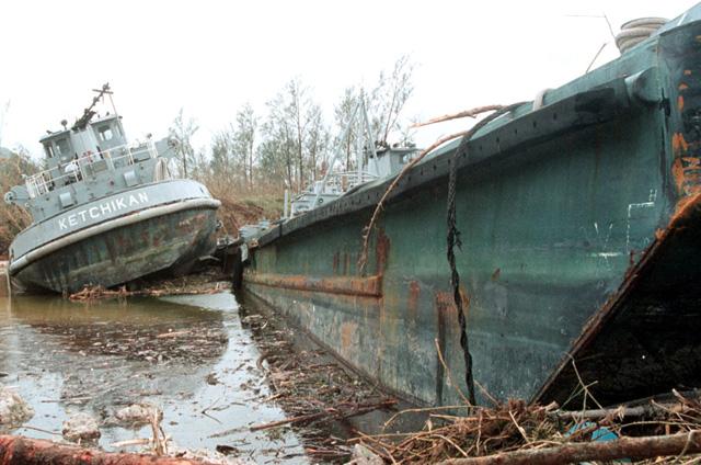 A damaged barge and river tug after the battle