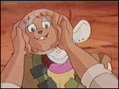 Harley holding a piece of flex-plate shielding, her face reflected in its surface.