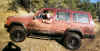 This is me after almost getting stuck in some terrible mud!  It was a marsh with mud spots over 3 feet deep in some spots.  We tried to aviod the really deep ones (no one there to tow us out), but we started to slip into one and I had to gun it out of there... ended up messing up my steering!