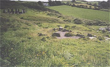 See the circle on the left of the pic, and the huts & cooking pits in the foreground, off in the distance you can just make out the ocean. 