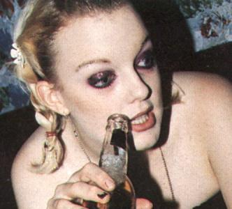 Lauren looking slightly sozzled and holding a bottle