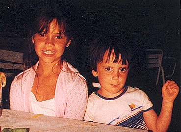 Tor showing her teeth and Christian showing his muscles