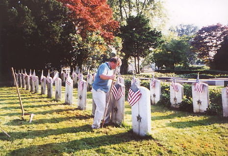 Brother Kennedy makes the finishing touches to the second row of grave markers at the Civil War Soldiers and Sailors Burial Plot.