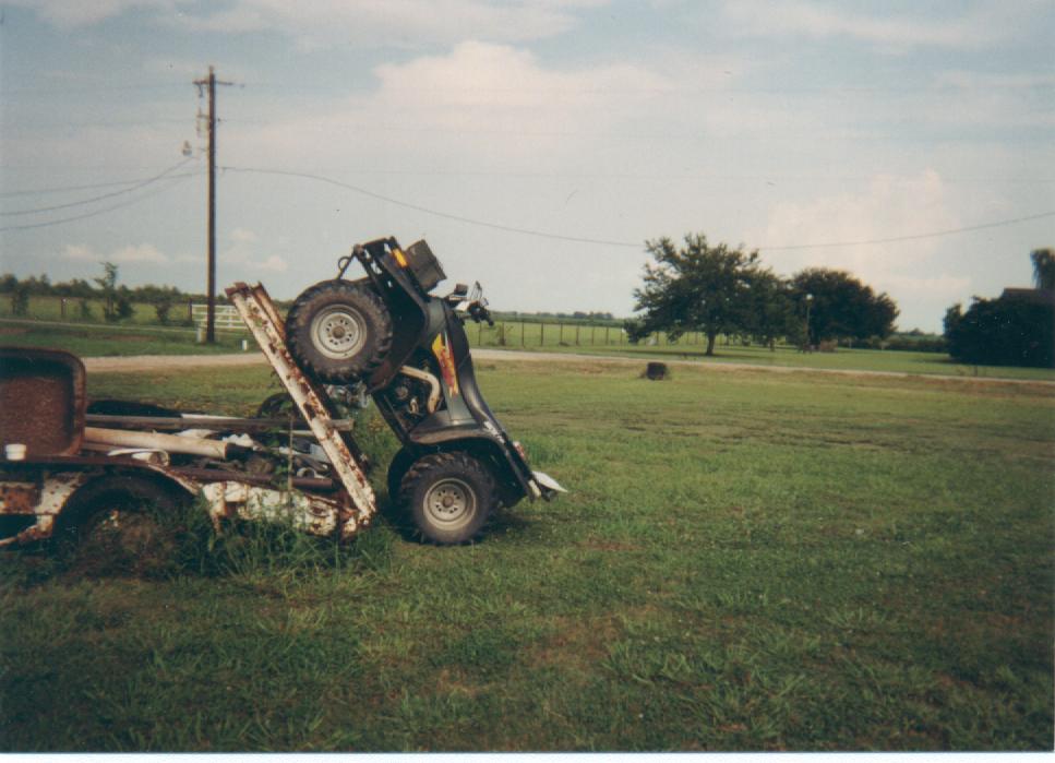 The Cat climbing a trailer ramp in the transport position.