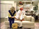 Joan adjusting Vicki's dress