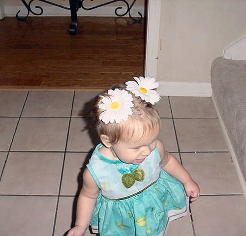 The cutest little girl in the world with daisies in her hair!