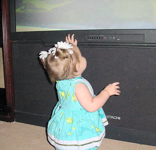 Maddie watches the big screen TV