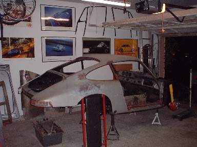 Click on pic for full-size image. The suspension is restored and back on the car-the posters on the walls serve as motovation :>