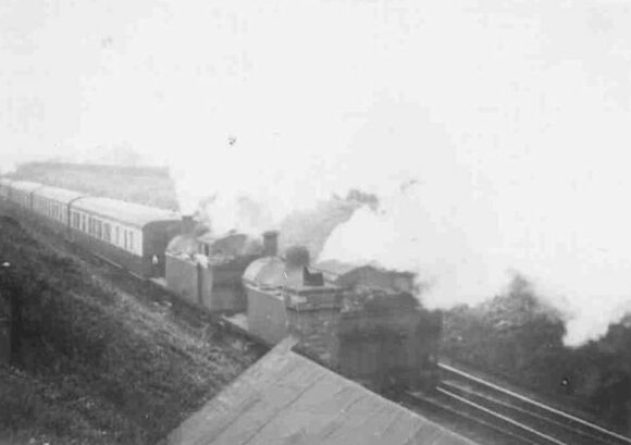 The two Jinty tanks assist at the ear of a passenger train, the last coach being of Hawksworth design