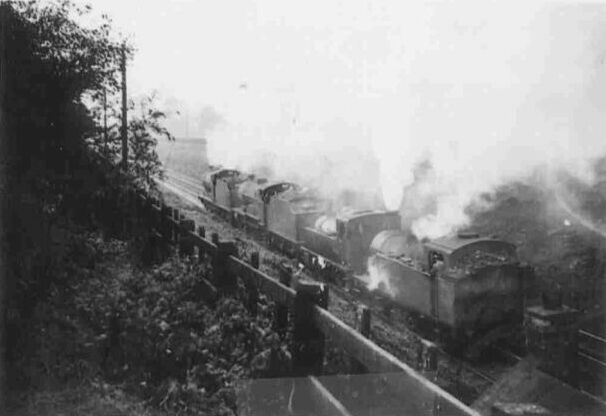 Three ex-Midland engines being assisted up the bank by one of the Jintys