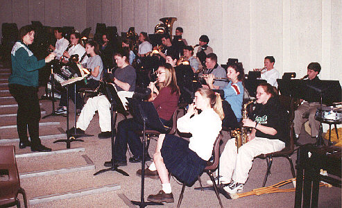 The band, conducted by Charlene Alfaro, plays the overture