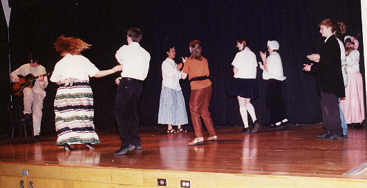 The cast dances the Virginia Reel