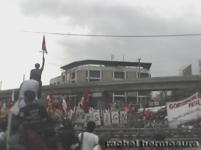 FROM THE OTHER SIDE OF THE FENCE. Photographers stand behind the statue of Don Chino Roces as they took pictures of the fast-approaching militant groups. The rallyists did not go past the barricades and held their program just a few meters away from the fences.