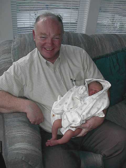 Uncle Gene checks Tyler's long legs and big feet.