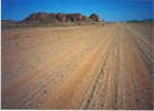 A typical Namibian road in the south. Beastie is the white speck in the photo