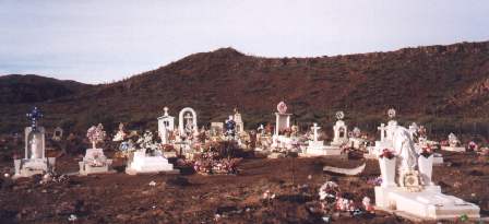Cemetary on gravel road in the middle of Desert 