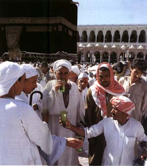 People performing hajj and drinking cups of free-flowing Zam Zam water, Makkah
