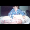 Joshua giving his new baby sister a bath.