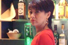 She is the owner of a small pub. This straightforward woman yells whenever angry but is optimistic about everything, bitterly laughs at the regrets of her life.