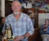 Darcy won this perpetual trophy. His wife Anne looks on (31kb)