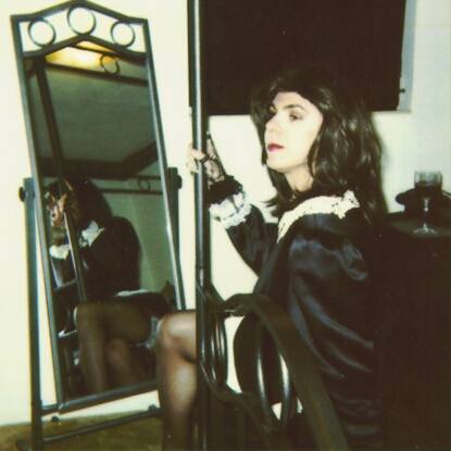 a custom-sewn French Maid's uniform, with several layers of red crenalations poofing out the skirt...