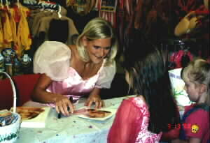 Barbie autographs a photo