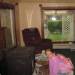 This is my younger daughter in our new house, May 10, 2007. Normally I would assume the orbs were ashes from the stove or something, except for the moving one up at the top of the picture.