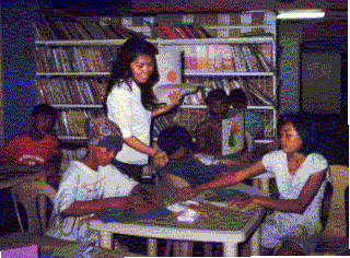Jenny Santos, one of our art teachers, with some of the children.