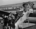 War Brides Wave While Disembarking Plane