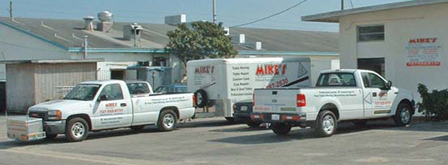  2 of the 4 tow vehicles and 1 of the 4 cargo trailers setup specially to transport pool tables and billiard tables safely in the 55 Counties in Florida that Mike's Billiard Supplies and Crating provides service to.
