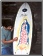 Artist painting the Surfboard
