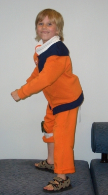 A little kid dressed as a ninja.